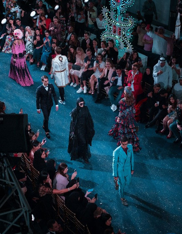 Overhead view of models walking down the runway at a fashion show